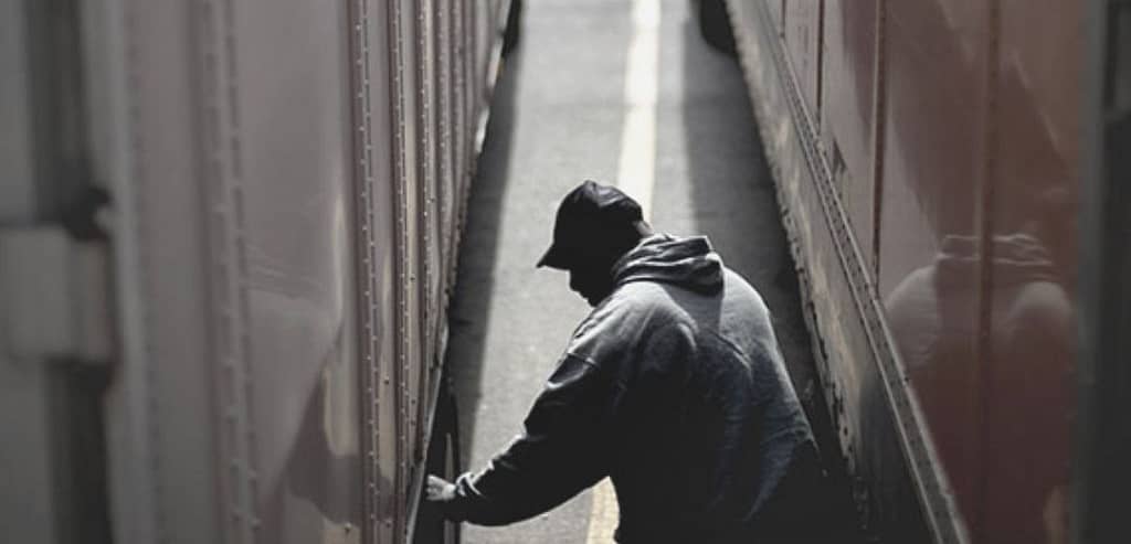 This image is of a criminal trying to tamper with packages in a facility. This image is used in the San Antonio-based BPS Security article titled, “Are Your Loading Docks Safe?”