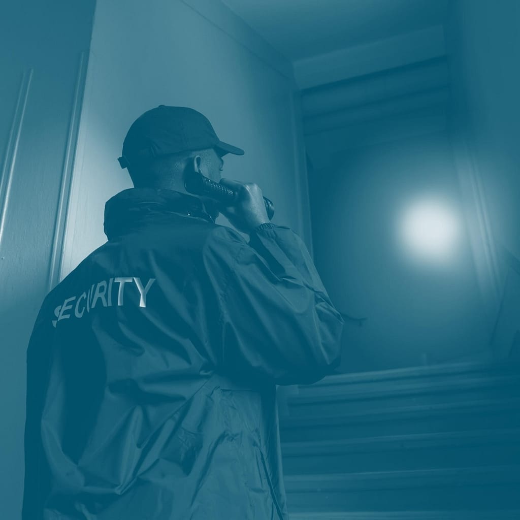 This is an image of a security guard making rounds at night. He is using his flashlight to scan an area that isn’t quite easy to see. This image is used in the BPS Security article titled, “Top 5 Things Every Security Guard Should Be Doing”.
