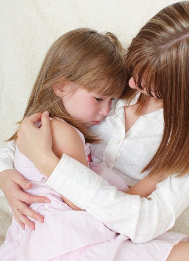 A child in her mother's arms showing the power of custody investigations that focus on the child's well being