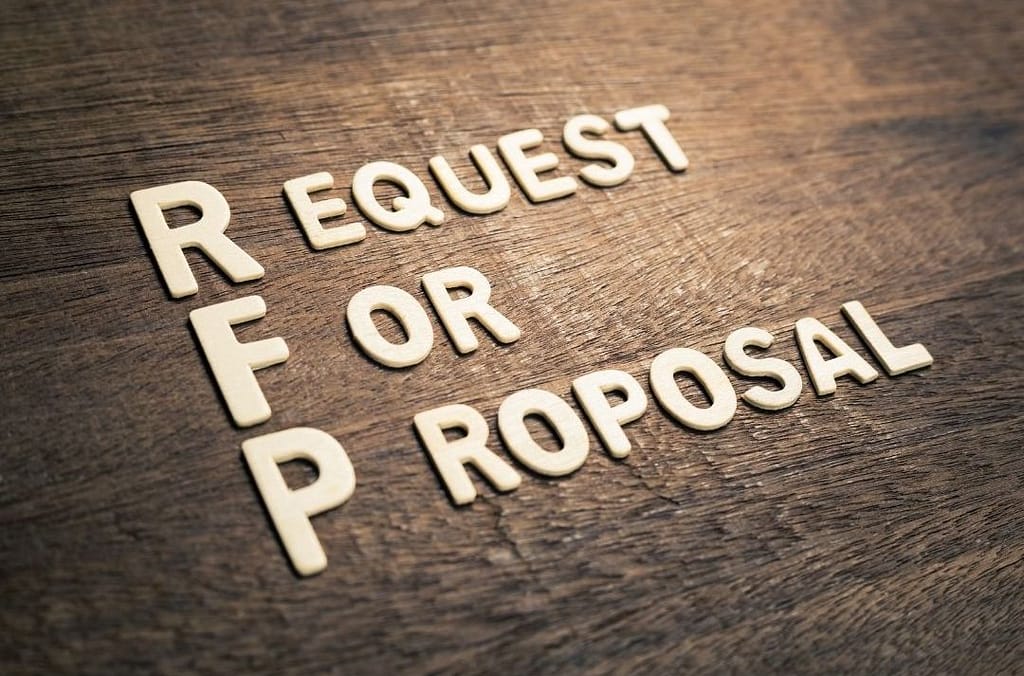 This is a picture of letters lying on a wooden desk that spell out “request for proposal”. This image is used in the BPS Security Article titled, “Why BPS Security Might Turn Down Potential Clients”.