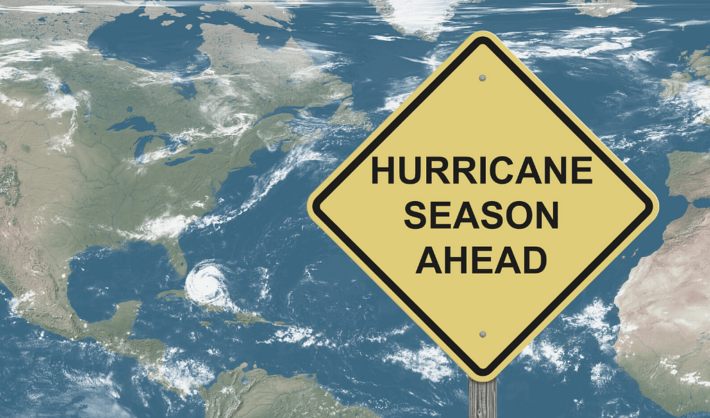 This is an image of the map of the atlantic ocean with a visible hurricane and a large sign that reads “hurricane season ahead”. This image is used in a BPS Security article titled “How to Help Prevent Looters During Emergency Evacuations”.