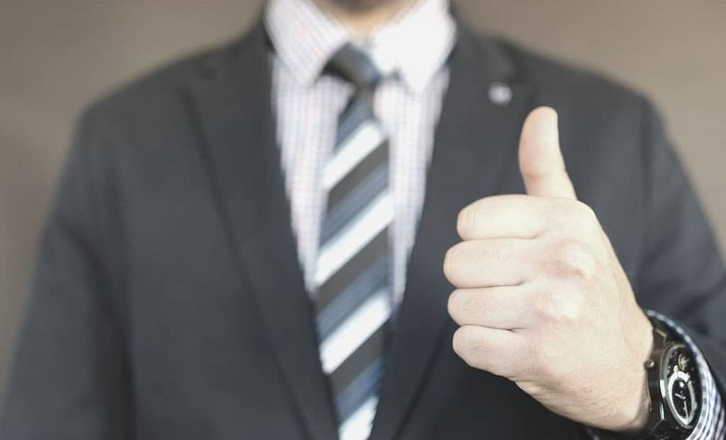 This image shows a business man giving a thumbs up! The image only shows the upper part of his body (excluding head), and only his thumbs up hand is in focus. This image is used in the BPS Security (based out of San Antonio, Texas) article titled, “Should I Hire My Own Security Team or Contract a Security Firm?”.