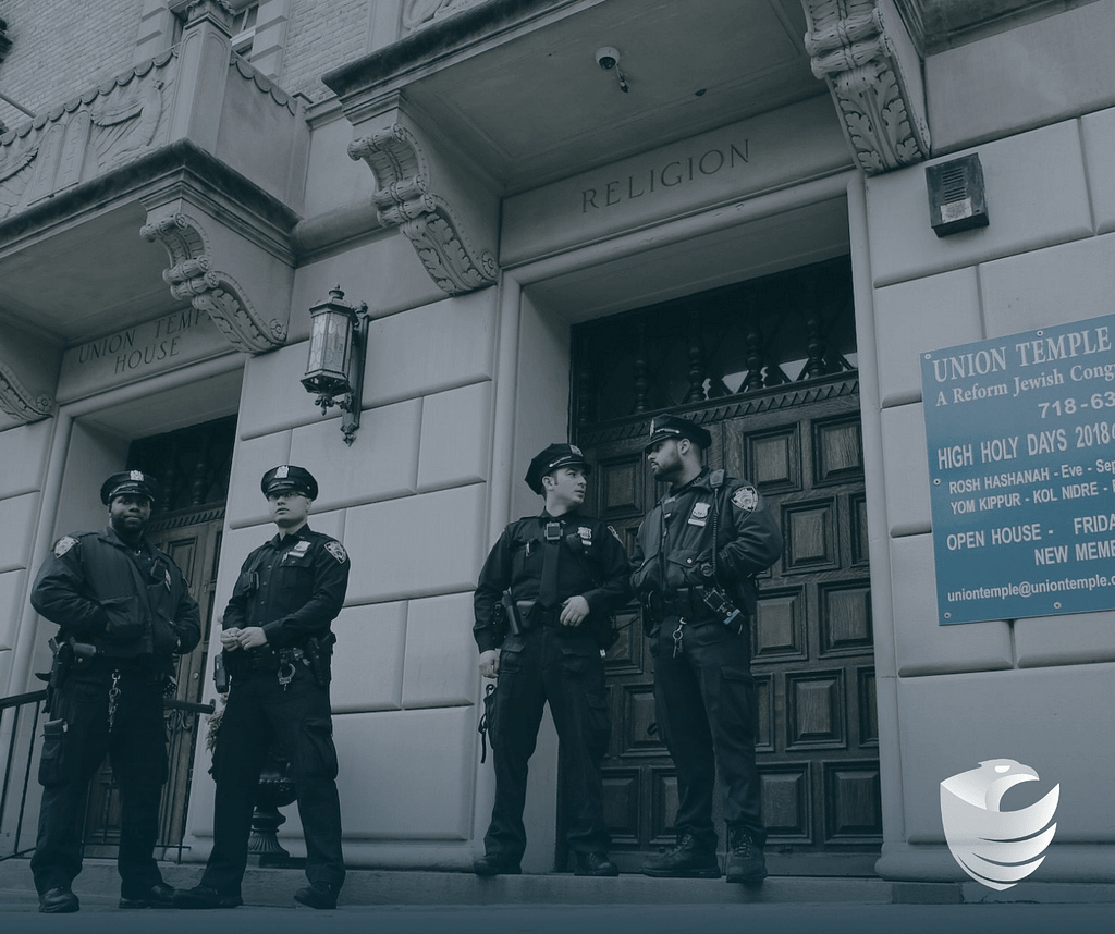 This image depicts security guards standing outside of a synagogue. This image is included in the BPS Security article titled, “3 Ways Private Security Can Protect Places of Worship and Keep Congregates Safe”