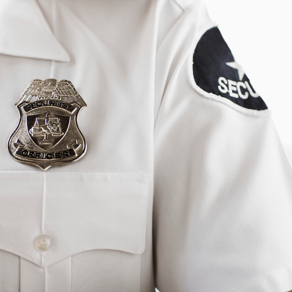 Closeup of a Security Guard's Uniform focusing in on upper left shoulder, showcasing their badge