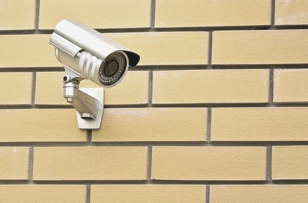 This image is of a security camera installed on a brick wall inside of a school. This image is used in the BPS Security Article, “How Can School Districts Increase Their Security Without Going Over Budget.”