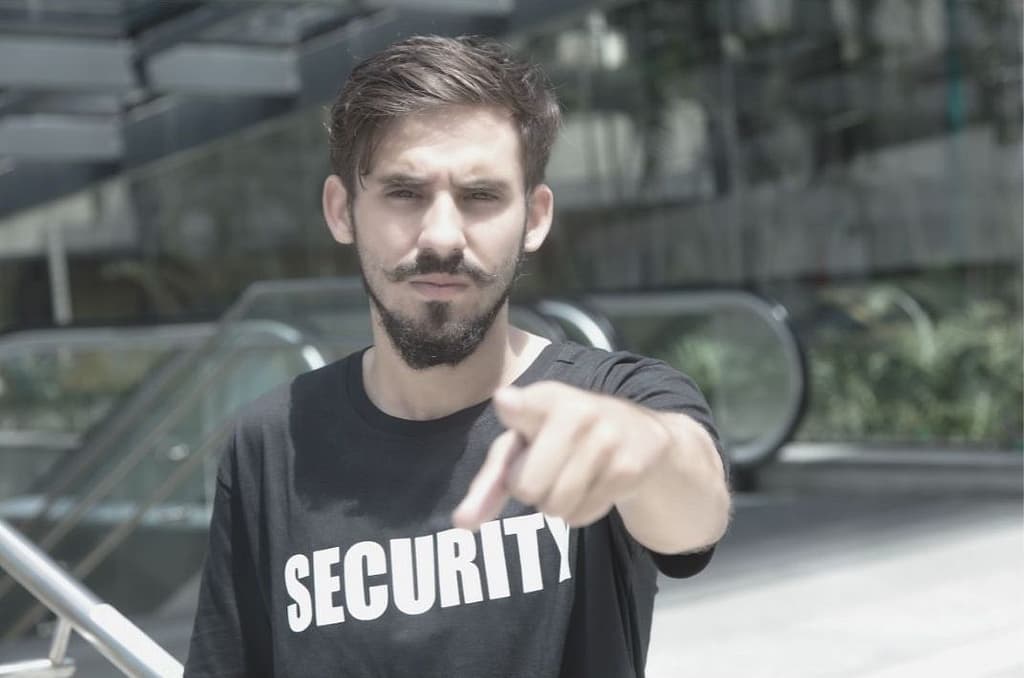 This image shows an angry security pointing directly at the camera in an aggressive manner. This image is used in the BPS Security article titled, “Companies Do NOT Want to Hire Hot-Headed Security Guards”.