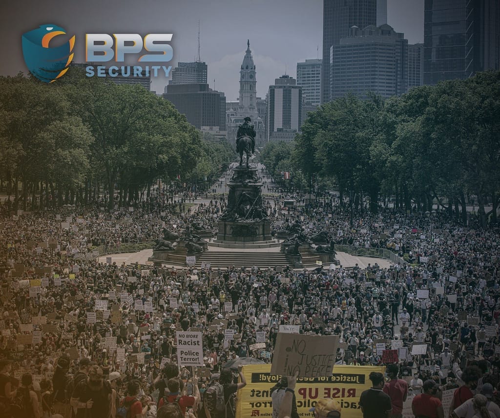 This image is one of a large protest. This image is included in the BPS Security article titled, “Why You Need a Security Detail: The Challenges of Protecting Politicians”