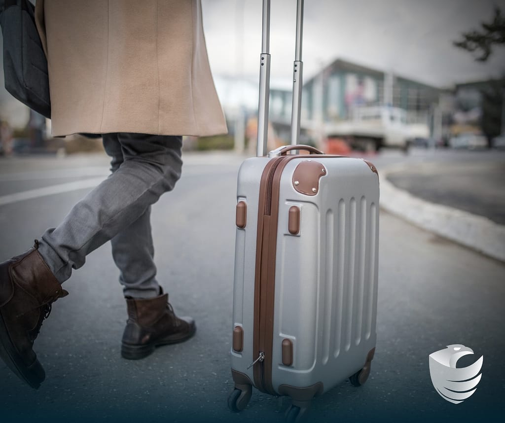 This image depicts a person rolling a suitcase outside. This image is included in the BPS Security article titled, “The Benefits of Hiring Private Security for Groups Traveling Abroad”