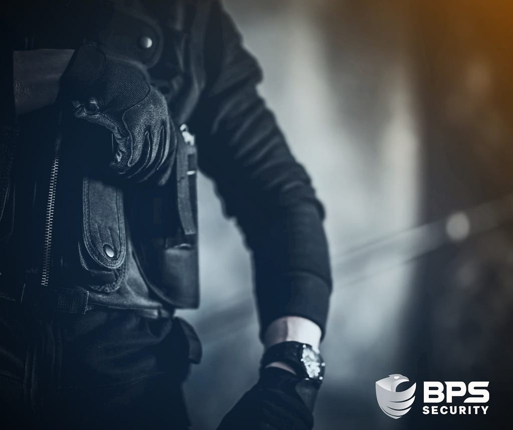 This image depicts a security officer with hand on his weapon. This is the supporter image used BPS Security blog titled, “Navigating Armed Security Training: What You Need to Know About Private Security Carrying Guns”