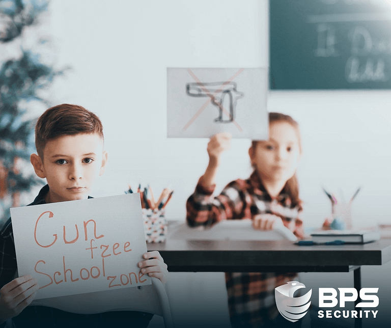 This image shows two school aged children holding up anti-gun signs for schools. This is the supporter image used in the BPS Security blog titled, “Enhancing School Security: The Evolving Role of Security Guards in Schools ”