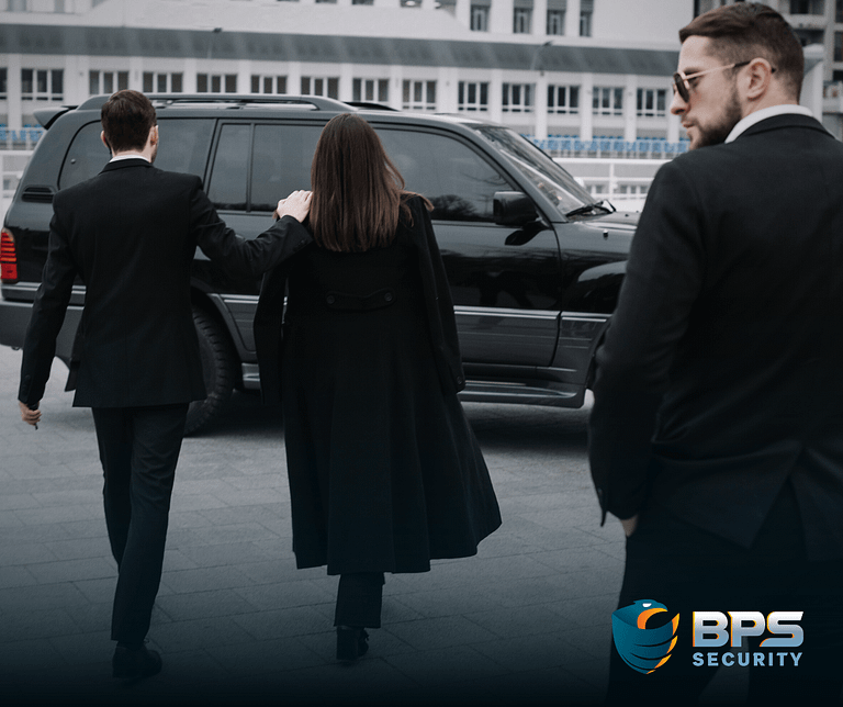 This image shows professionally dressed security guards walking a VIP to her car. This is the supporter image used in the BPS Security blog titled, “The Importance of Maintaining a Professional and Discreet Image as Private Security Personnel''